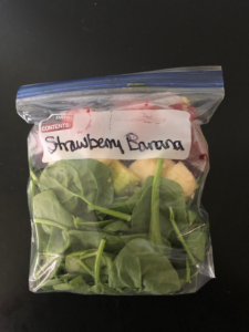 Freezer bag with smoothie ingredients labeled strawberry banana.